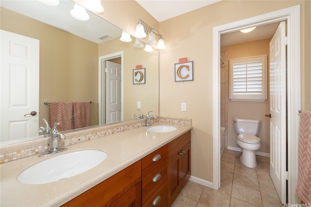 bathroom featuring toilet, visible vents, a sink, and double vanity