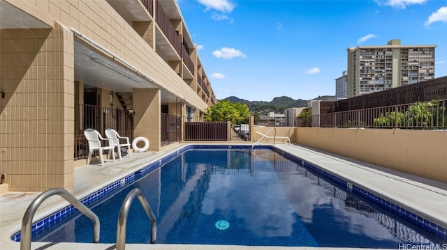 view of pool with a mountain view and a patio area