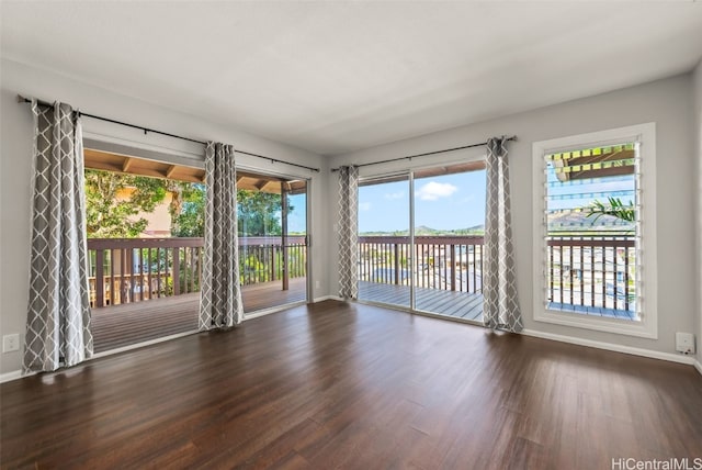 unfurnished room featuring dark wood-type flooring