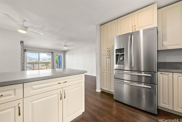 kitchen featuring dark hardwood / wood-style flooring, cream cabinets, stainless steel fridge, and ceiling fan