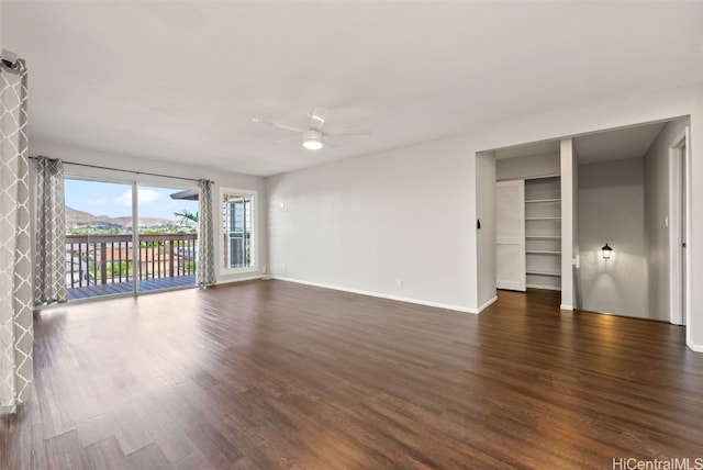 empty room featuring dark hardwood / wood-style floors and ceiling fan