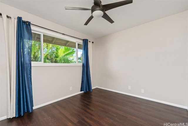 spare room with ceiling fan and dark hardwood / wood-style flooring