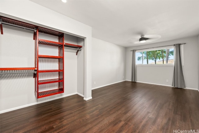 interior space with dark hardwood / wood-style flooring and ceiling fan