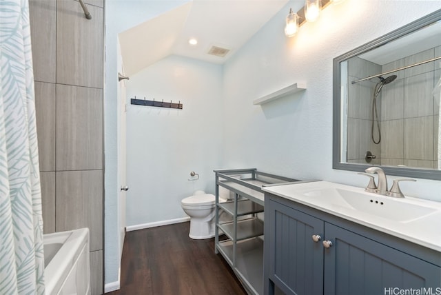 full bathroom with vanity, hardwood / wood-style flooring, shower / bath combo, and toilet