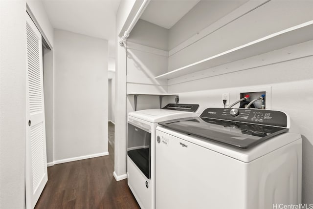 laundry area featuring dark hardwood / wood-style flooring and washing machine and dryer