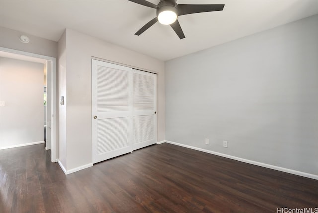 unfurnished bedroom with ceiling fan, dark hardwood / wood-style flooring, and a closet