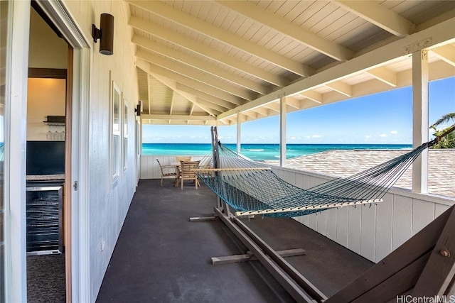 exterior space with a water view and a view of the beach