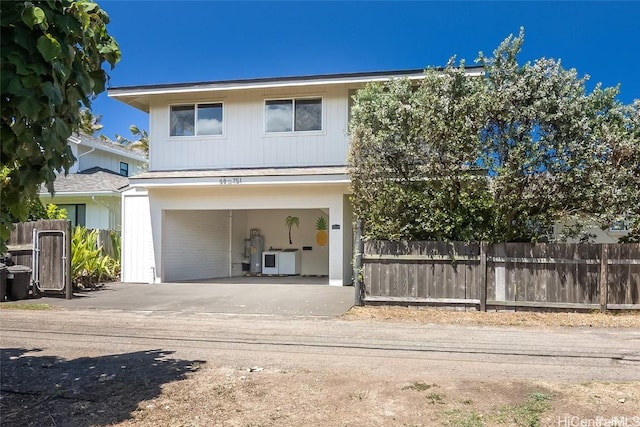 view of front of house with a garage and water heater