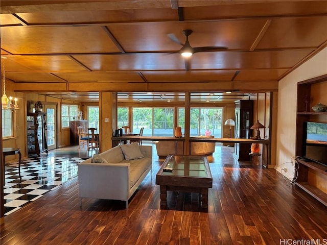 living area with hardwood / wood-style floors, beamed ceiling, and ceiling fan