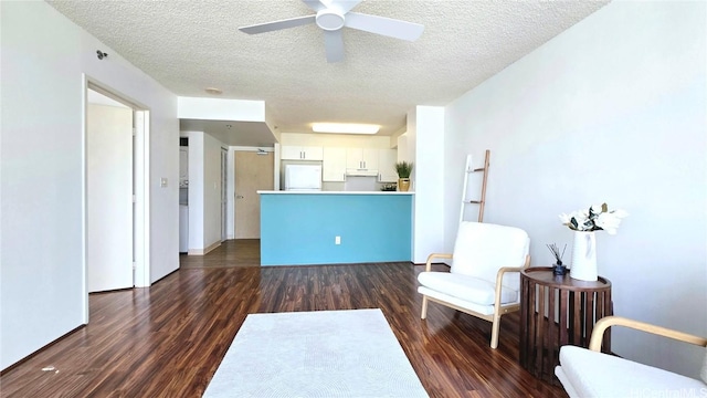 unfurnished room with ceiling fan, dark hardwood / wood-style floors, and a textured ceiling