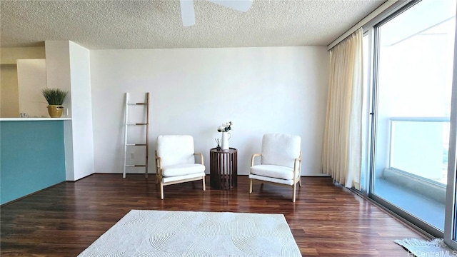 unfurnished room with ceiling fan, a textured ceiling, and dark hardwood / wood-style flooring