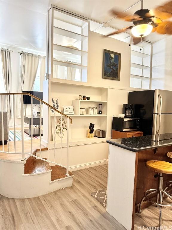 kitchen featuring light hardwood / wood-style floors, ceiling fan, and appliances with stainless steel finishes