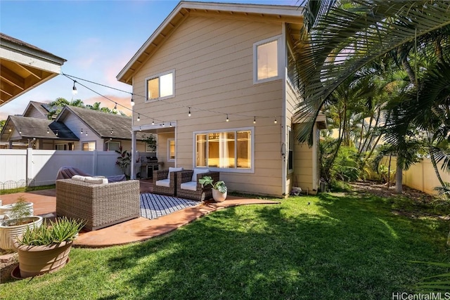 back of house with a yard, an outdoor living space, and a patio area