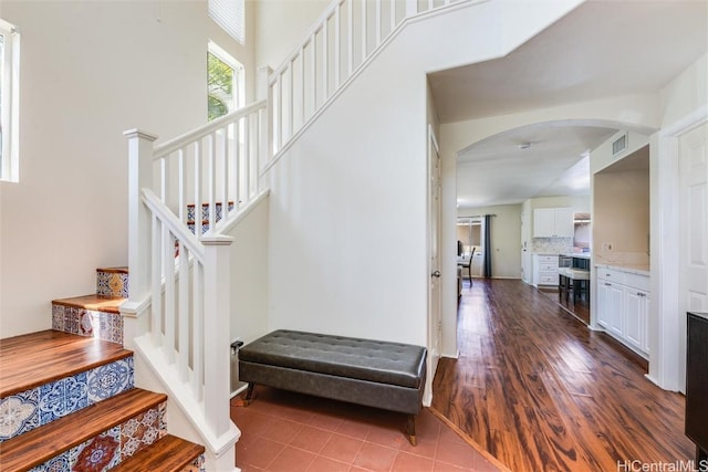 staircase with hardwood / wood-style floors