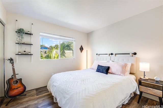 bedroom with dark hardwood / wood-style floors