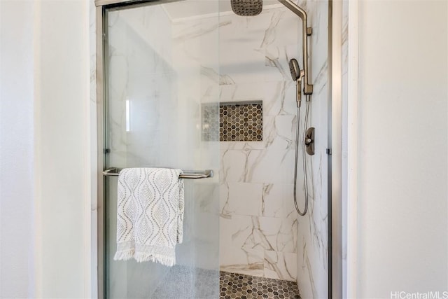 bathroom featuring a shower with shower door