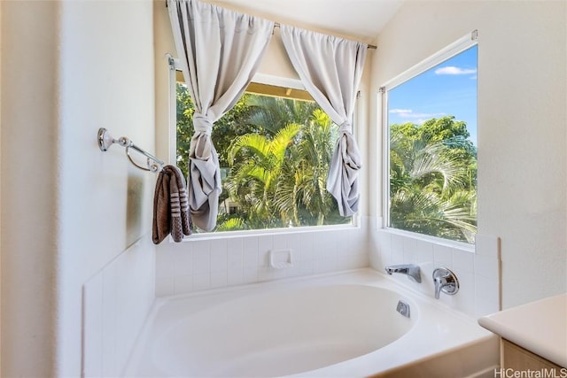 bathroom featuring a bathtub and a wealth of natural light