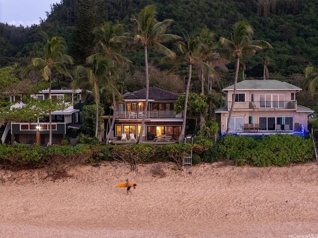 59-377 Ke Nui Rd, Haleiwa, HI 96712 - rear view of property featuring a balcony and a wooded view
