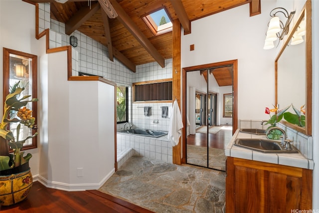 59-377 Ke Nui Rd, Haleiwa, HI 96712 - full bath featuring wooden ceiling, wood finished floors, a skylight, baseboards, and tiled tub