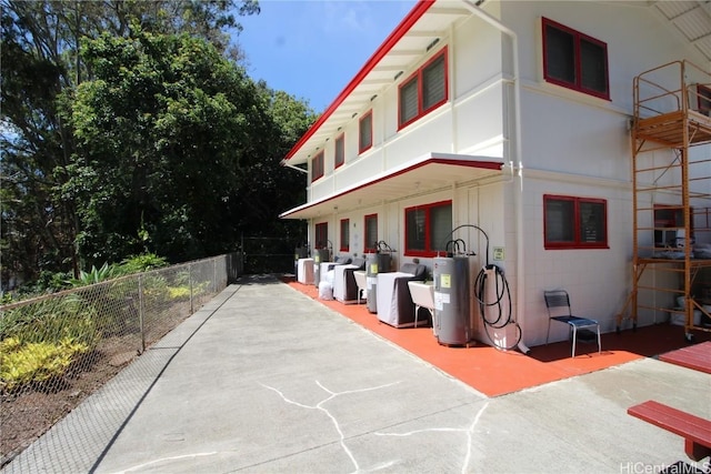 view of front of property with a patio and electric water heater