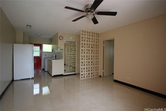 unfurnished living room featuring ceiling fan