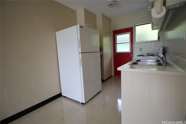 kitchen with sink and white refrigerator