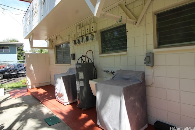 view of patio with washer / clothes dryer and electric water heater