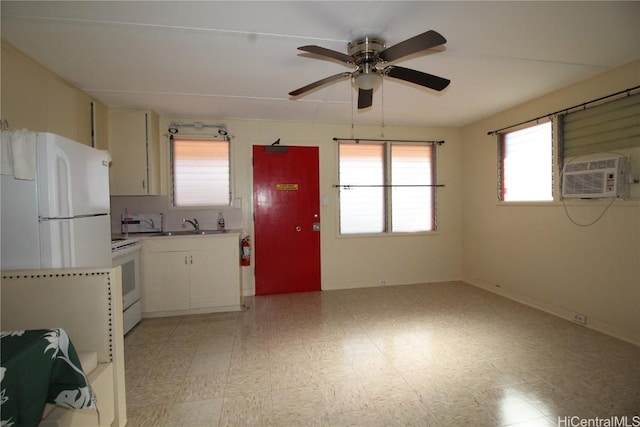 kitchen featuring sink, ceiling fan, cooling unit, white electric range oven, and an AC wall unit