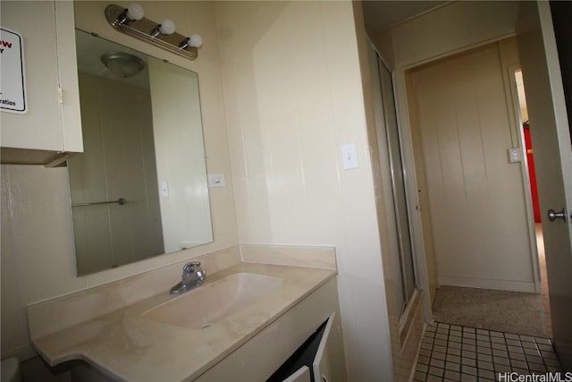 bathroom featuring walk in shower and vanity