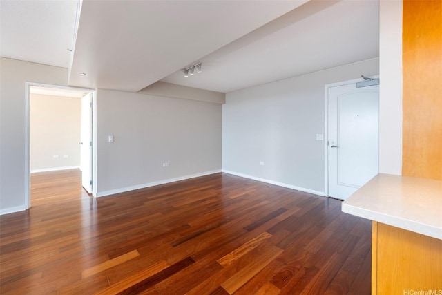 1288 Kapiolani Blvd Unit I-1707, Honolulu, HI 96814 - unfurnished room featuring dark wood-style flooring, baseboards, and track lighting