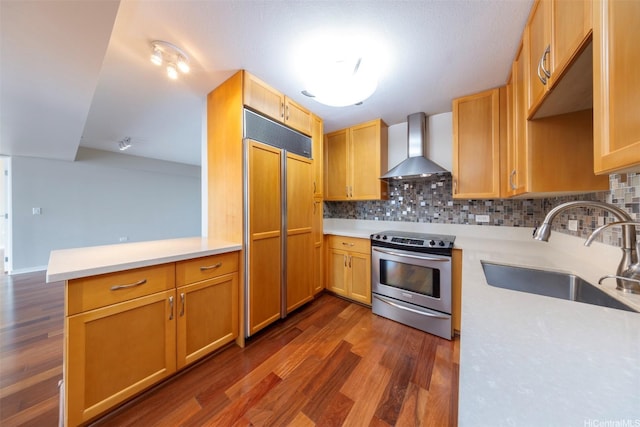 1288 Kapiolani Blvd Unit I-1707, Honolulu, HI 96814 - kitchen with wall chimney exhaust hood, stainless steel electric stove, paneled fridge, a sink, and dark wood-style floors