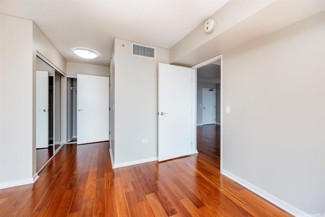 1288 Kapiolani Blvd Unit I-1707, Honolulu, HI 96814 - unfurnished bedroom featuring wood finished floors and baseboards