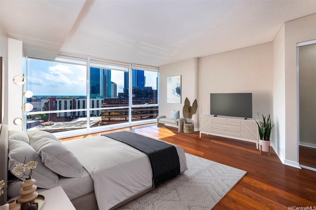 1288 Kapiolani Blvd Unit I-1707, Honolulu, HI 96814 - bedroom with wood finished floors, access to exterior, a wall of windows, and baseboards