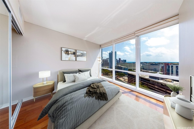 1288 Kapiolani Blvd Unit I-1707, Honolulu, HI 96814 - bedroom with a view of city, wood finished floors, baseboards, and expansive windows