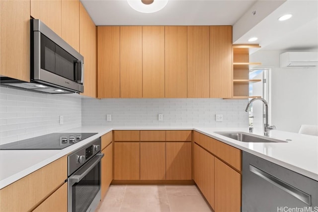 kitchen with a wall mounted AC, a sink, stainless steel appliances, light countertops, and decorative backsplash