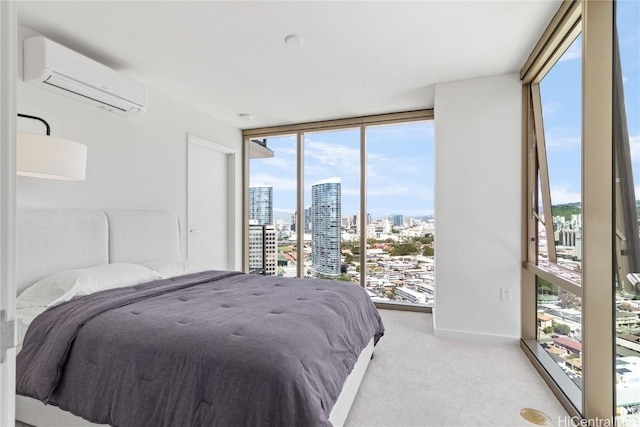 bedroom featuring baseboards, carpet, a city view, floor to ceiling windows, and a wall unit AC