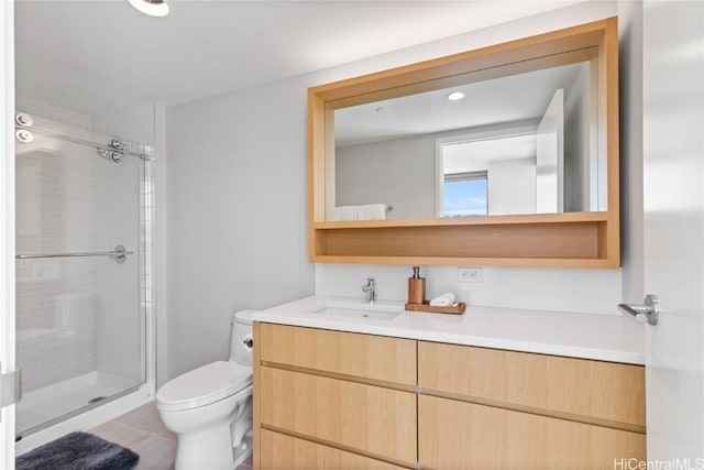 bathroom with vanity, toilet, a shower stall, and tile patterned flooring