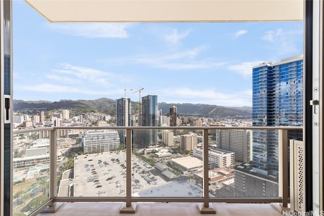 balcony featuring a view of city and a mountain view