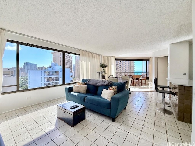 tiled living room featuring a textured ceiling