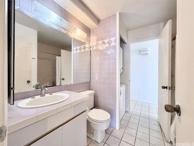 bathroom with tile patterned flooring, vanity, tile walls, and toilet