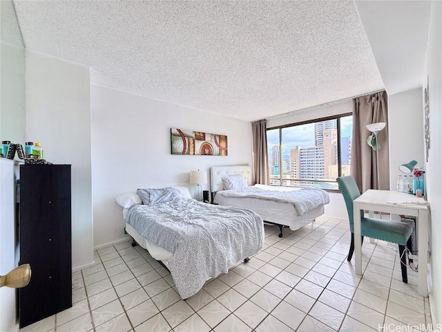 tiled bedroom with a textured ceiling