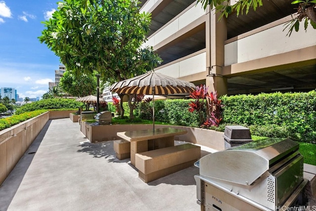 view of property's community featuring exterior kitchen and a patio area