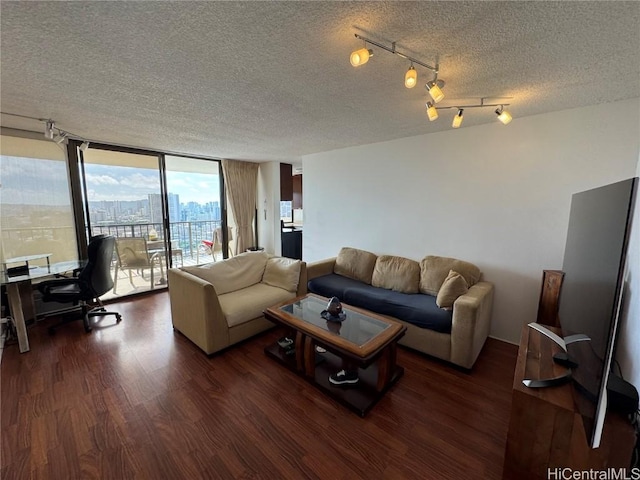 living room featuring a view of city, a wall of windows, dark wood-style floors, and a textured ceiling