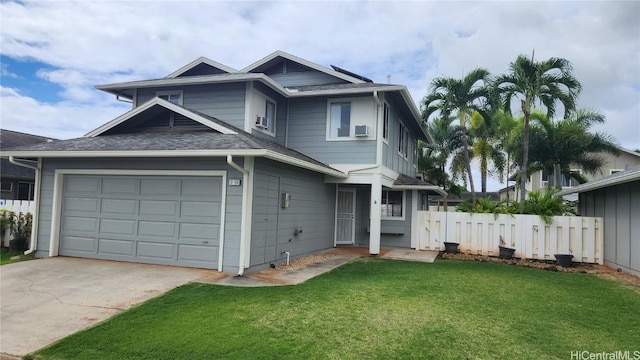 view of front of house with a garage and a front lawn