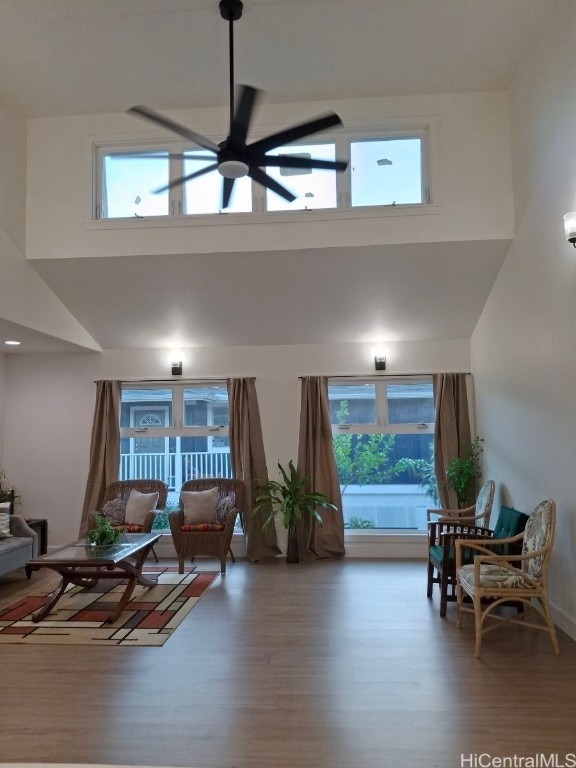 living room with hardwood / wood-style flooring, a wealth of natural light, and ceiling fan