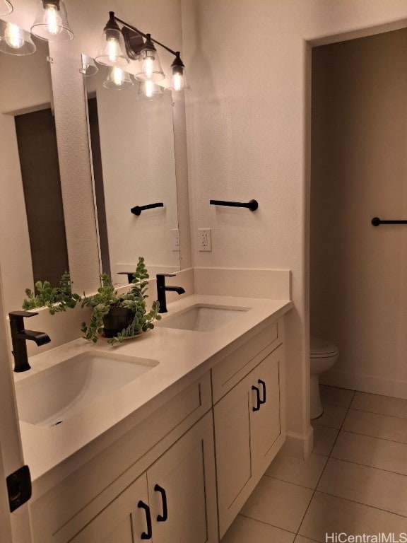 bathroom featuring vanity, tile patterned floors, and toilet