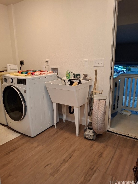 clothes washing area with washer hookup, wood-type flooring, and electric dryer hookup