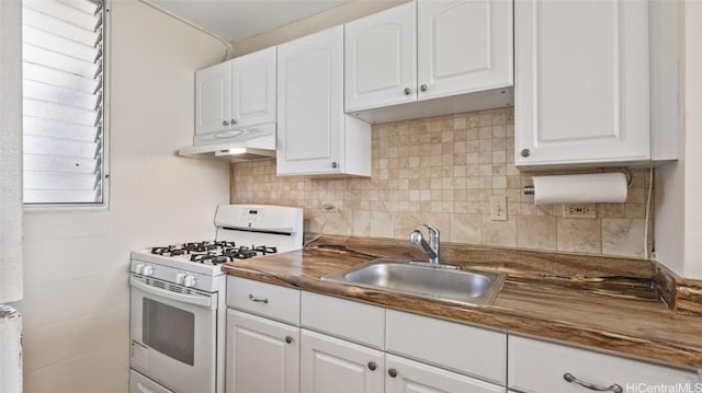 kitchen featuring tasteful backsplash, white range with gas cooktop, sink, and white cabinets