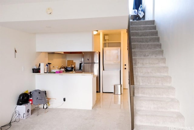 interior space with carpet and stacked washer and dryer