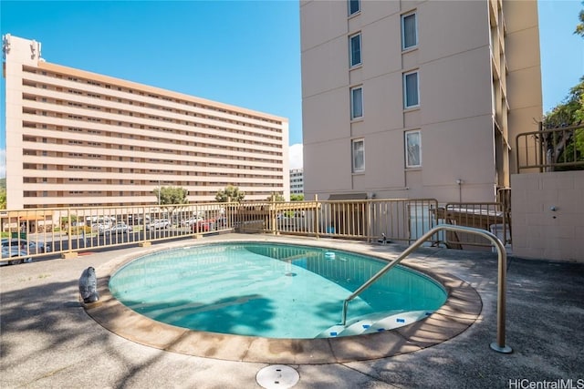 view of pool with a pool and fence